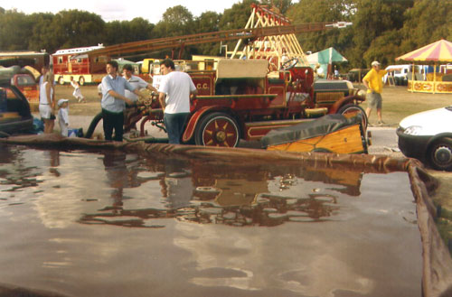 This old fire engine is a 1909 Dennis owned by a London collage, the students drove the engine down from London for the event. The photo was taken at the Havenstreet Steam Extravaganza and shows the fire engine pumping out our pool at the end of the rally. 